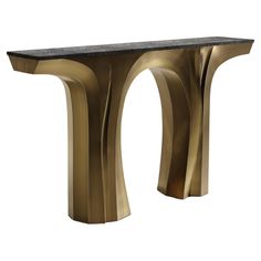 a black and gold console table with curves on the top, in front of a white background