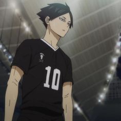 an anime character with black hair wearing a soccer uniform and looking at the camera while standing in a stadium