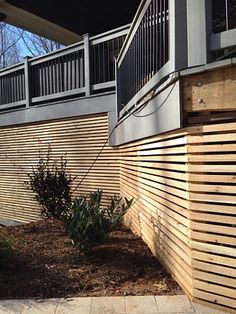 a wooden fence next to a building with balconies