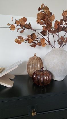 there are two vases on top of the dresser