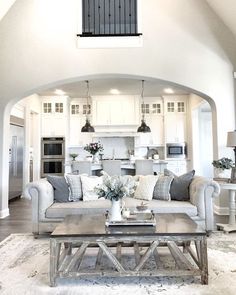 a living room filled with furniture and white walls