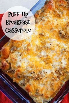 a casserole dish with meat and cheese in it on a red cloth next to a fork