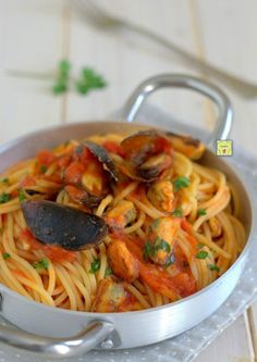 pasta with clams and tomato sauce in a pan