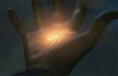 a person's hand with light shining through it