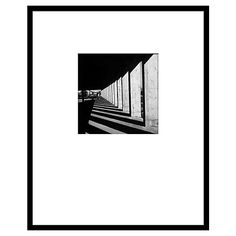 a black and white photo of a long hallway