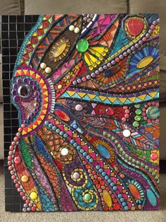 a colorful painting with lots of beads on it