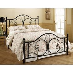 a bed with a metal frame and headboard