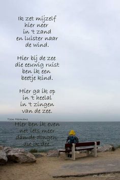 a person sitting on top of a bench near the ocean with a poem written in it