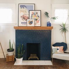 a living room with a fire place and pictures on the fireplace mantel above it