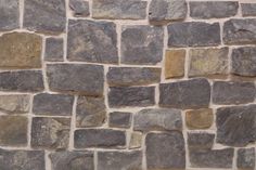 a stone wall that is made out of different types of rocks