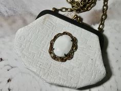 "One of a Kind vintage white coin purse. This coin purse is really in perfect condition, which is rare. I added a piece of vintage jewelry to add a bit of charm. It would make the perfect gift. I T E M ∙ S P E C I F I C A T I O N S - PURSE SIZE: 4\" x 3\"  frame opens about 2\" and you could put something little inside - CHAIN LENGTH: 52\" total length brass link chain, you can double the chain and make the necklace short C A R E ∙ T I P S: We don't want your special moment to fade. To maintain Vintage Rectangular Jewelry For Everyday Use, Handmade White Rectangular Coin Purse, Vintage Handmade Coin Purse For Weddings, Vintage Handmade Coin Purse For Wedding, Handmade Vintage Coin Purse For Wedding, Handmade White Coin Purse For Gift, Handmade White Coin Purse As Gift, Vintage Handmade Coin Purse For Gift, Body Necklace