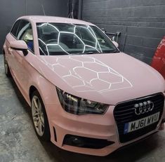 a pink car is parked in a garage