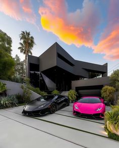 two pink and black lambs parked in front of a large modern house with palm trees