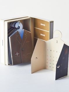 an open book with some pictures in it and a clock on the front, inside