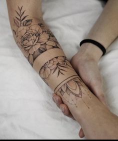 a woman's arm with flowers on it