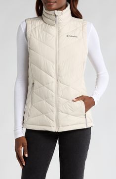 This quilted vest combines thermal reflective technology and plush fill so you'll stay warm to your core on trail walks or strolls through town. A cozy, fleece lined collar brings warmth up close when you need it most and front zip pockets let you carry the essentials. 25" length Front zip closure Stand collar Water repellent Front zip pockets Lined, with polyester fill 100% polyester Machine wash, tumble dry Imported Winter Vest With Fleece Lining For Outdoor Activities, Winter Hiking Vest Outerwear, Winter Hiking Outerwear Vest, Sleeveless Outerwear With Fleece Lining For Hiking, White Sleeveless Outdoor Outerwear, Winter Windproof Hiking Vest, Winter Hiking Vest With Fleece Lining, Winter Hiking Windproof Vest, Quilted Winter Vest For Outdoor