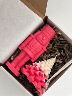 a pink toy in a box with other toys