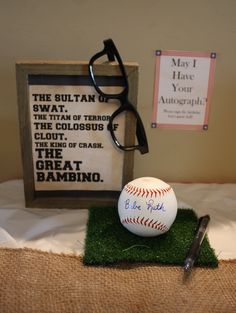 a pair of glasses sitting on top of a table next to a baseball