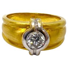 a gold and silver ring with a diamond