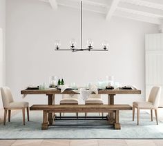 a dining room table with chairs and a bench in front of it on a rug