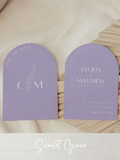 the wedding stationery is laid out on a wicker mat and placed next to each other