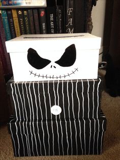 a stack of halloween boxes with jack skellings on the front and sides, all decorated in black and white stripes