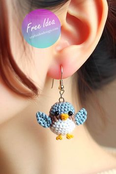 a close up of a person wearing earrings with a bird on it's ear