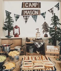 a table filled with hot dogs and other foods