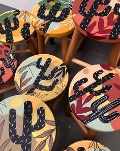 several colorful stools with cactus designs on them