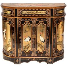 an ornate black and gold cabinet with birds on it