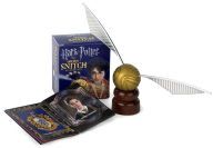 a harry potter book and quill - pen are on display in front of a box