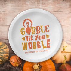 a paper plate with the words gobble tie you wobble on it surrounded by pumpkins and gourds