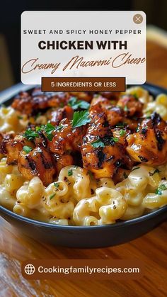 chicken with creamy macaroni and cheese in a black bowl on a wooden table