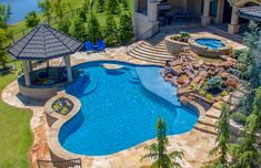 an aerial view of a backyard with a swimming pool and gazebo in the middle