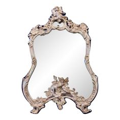 an ornately decorated mirror is shown against a white background