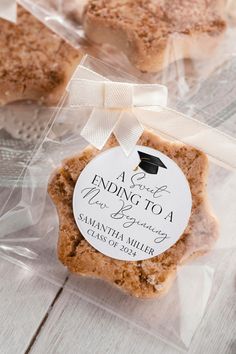 some cookies are wrapped in plastic and tied with a white ribbon on the top one has a graduation cap