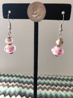 "Our colors are Blush and Bashful!" These pink and white earrings have small flowers inside. A hint of green and silver is present to help solidify any floral ensemble! Spring Pink Earrings With Flower Charm, Pink Drop Earrings For Spring, White Floral Print Flower Earrings, Elegant Floral Print Earrings For Spring, Pink Dangle Flower Earrings Nickel Free, Pink Flower Beaded Earrings For Gift, Nickel-free Pink Dangle Flower Earrings, Pink Flower Earrings With Ear Wire For Spring, Pink Beaded Earrings For Spring Gift