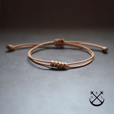 "This is a listing for 1 simple snakeknot bracelet in the colour of your choice.  - thickness: 1mm string (more strings at the same time) - 100% handmade in France - the bracelet will wrap once around your wrist and makes for a nice subtle accessory bringing out the outdoor and adventurous person in you. - this bracelet makes a great gift, the bracelet comes in a fabric gift bag ready to be offered as a present. The colour strap used in the picture is light brown and khaki green.  SIZE There are Minimalist Braided Bracelet For Gift, Minimalist Braided Bracelet Gift, Minimalist Brown Braided Bracelet As Gift, Minimalist Braided Bracelet With Sliding Knot, Bracelet Couples, Couples Jewelry, Fabric Gift Bag, Bracelet Cord, Knotted Bracelet