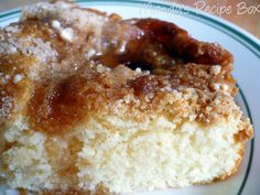 a close up of a doughnut on a plate with powdered sugar and syrup