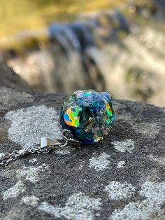 This is a unique blue mixed medium resin orb necklace! I used rainbow translucent pieces, multi color glitter chunks, gold and silver flakes to create this pendant! This necklace is a unique with a lot of shine and different looks from different angles! This would be a great addition to your collection or as a special gift! Check out my page for the matching ring! This pendant comes in two sizes (Medium 1.25 tall by .75 wide) or (Large 1.50 tall by 1 wide) (Please choose your size at checkout) T Celestial Resin Jewelry For Gifts, Celestial Resin Jewelry As A Gift, Celestial Resin Jewelry As Gift, Celestial Style Resin Jewelry For Gifts, Iridescent Resin Round Jewelry, Magical Blue Pendant Jewelry, Blue Resin Round Pendant Necklace, Blue Spiritual Resin Necklaces, Magical Silver Resin Jewelry