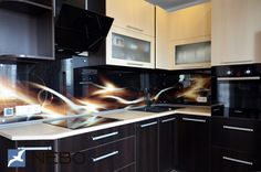 a modern kitchen with black cabinets and white counter tops is seen in this image from the front view