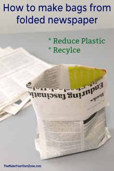 a newspaper bag with the words reduce plastic recycle written on it and next to it is a pile of newspapers