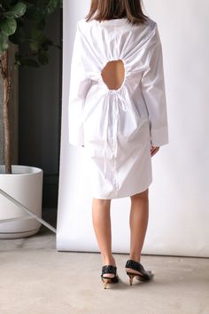 Sale items are final sale. No returns or exchanges. Proenza Schouler White Label Soft Poplin Button Down Shirt is cut from stretch cotton to a long, fitted silhouette that nips in at the waist with a slim belt. Featuring a ruched cut-out and self-ties at the back. Need further assistance? Text our stylists for more details about fit, fabrication, photos etc! True to size Machine wash Off White Point collar Drop shoulders Long sleeves Self-tie waist belt Ruched cut-out at back Curved hem Button f Slimmer Belt, Button Down Dress, White Label, Fitted Silhouette, Slingback Pump, Proenza Schouler, Waist Belt, Stretch Cotton, Sale Items