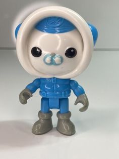 a blue and white toy with black eyes