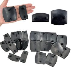 several pieces of black plastic with holes in the middle and one piece being held up by someone's hand