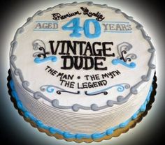 a white cake with blue frosting and the words vintage dude on it's side