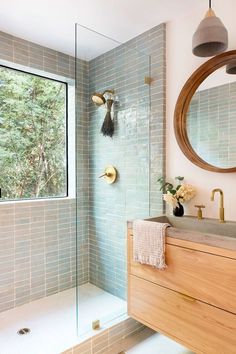 a bathroom with a sink, mirror and shower