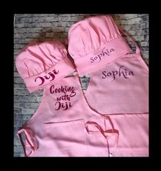 three pink aprons with the words cooking with joy written on them