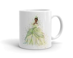 a white coffee mug with an image of a woman in a green dress on it