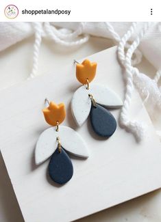 two pairs of earrings on top of a piece of paper